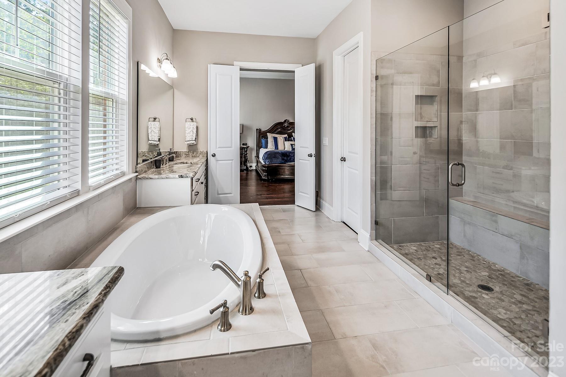 1004 Princessa Drive Wesley Chapel, NC 28104 - Photo 24 of 40 a large tub sitting next to a bathroom sink