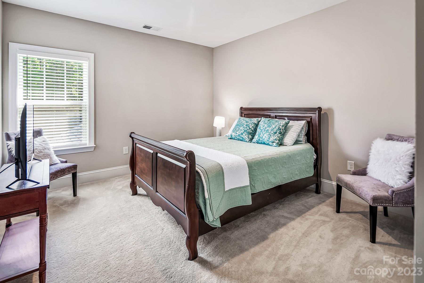 1004 Princessa Drive Wesley Chapel, NC 28104 - Photo 29 of 40 a bedroom with a bed chair and two window