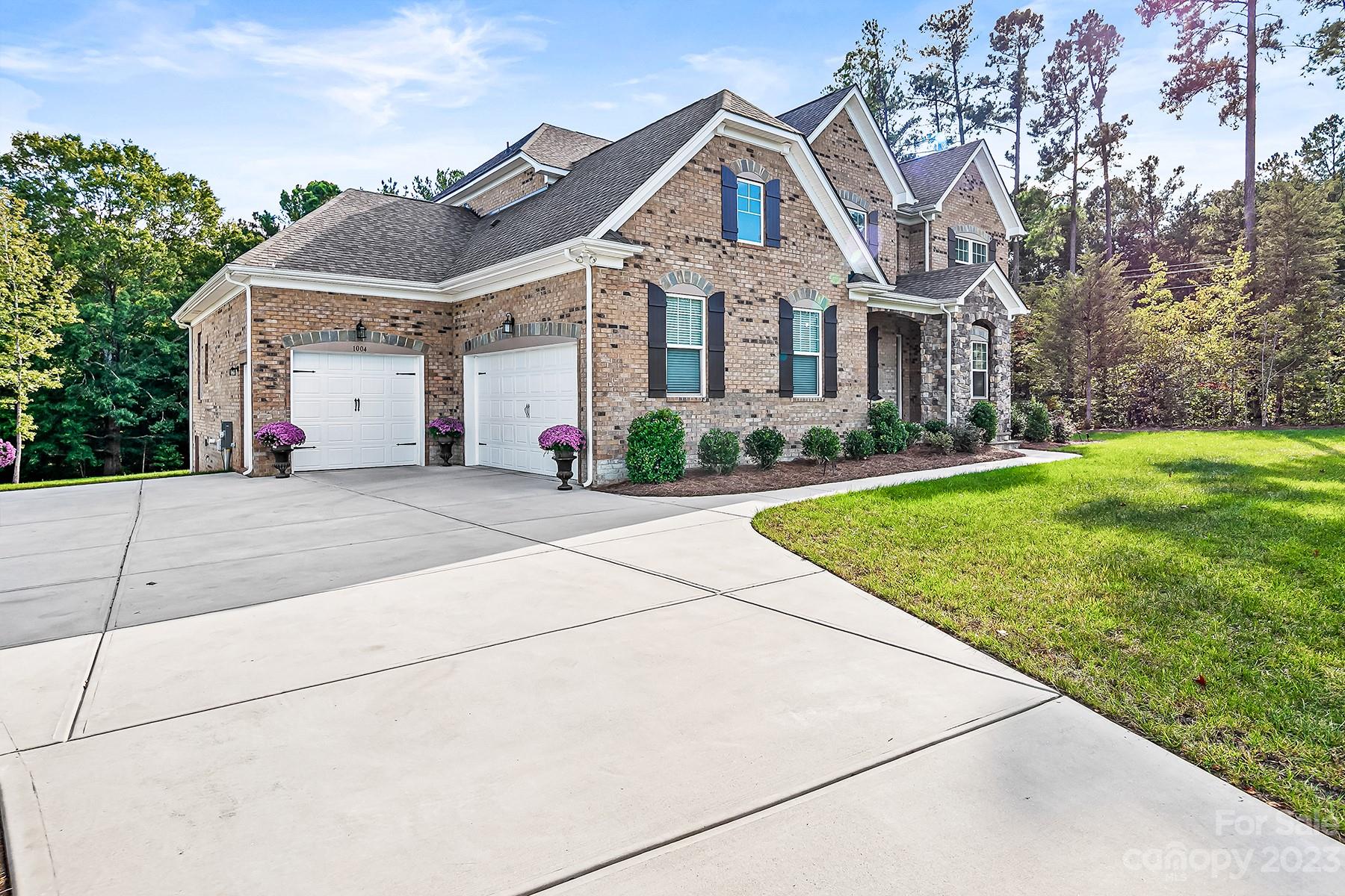 1004 Princessa Drive Wesley Chapel, NC 28104 - Photo 3 of 40 a front view of a house with a yard and trees