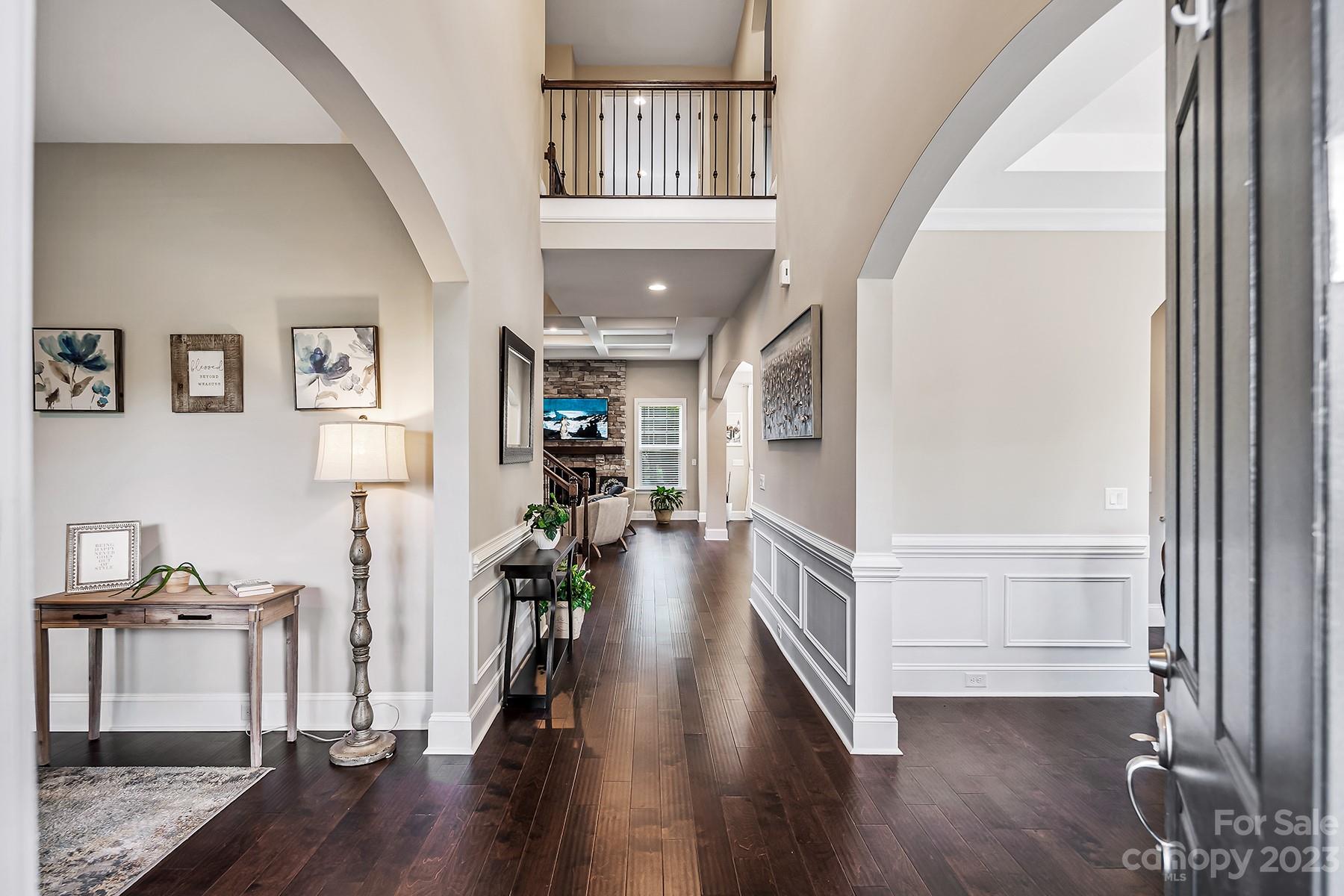 1004 Princessa Drive Wesley Chapel, NC 28104 - Photo 5 of 40 a view of a hallway with wooden floor and staircase