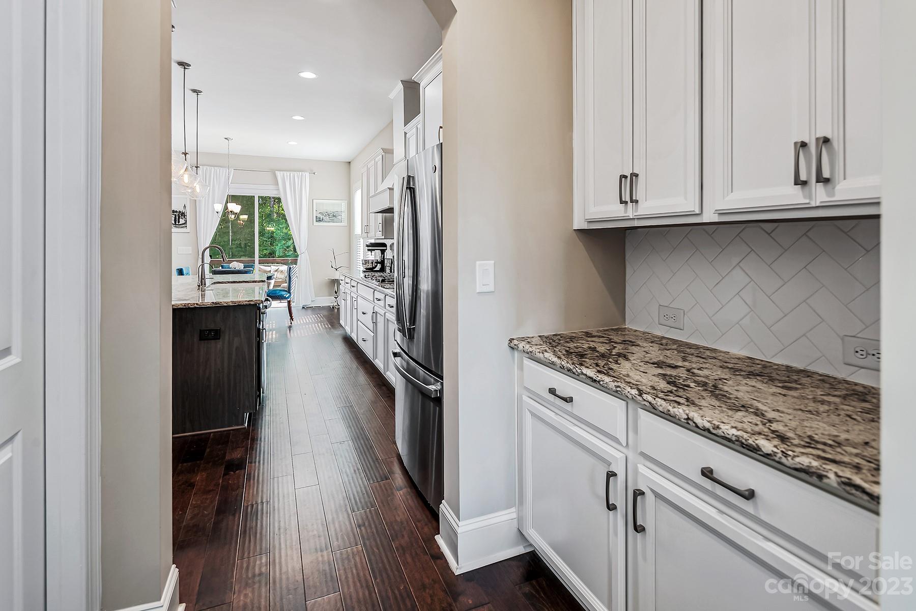 1004 Princessa Drive Wesley Chapel, NC 28104 - Photo 10 of 40 a kitchen with stainless steel appliances granite countertop a refrigerator and a stove
