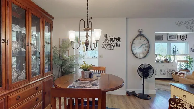 a view of a room with furniture and chandelier