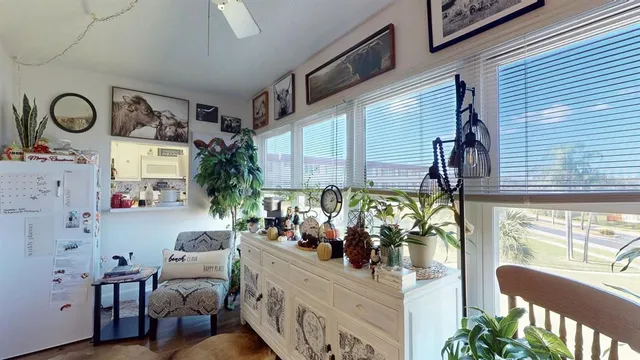 a kitchen filled with a potted plant and a table