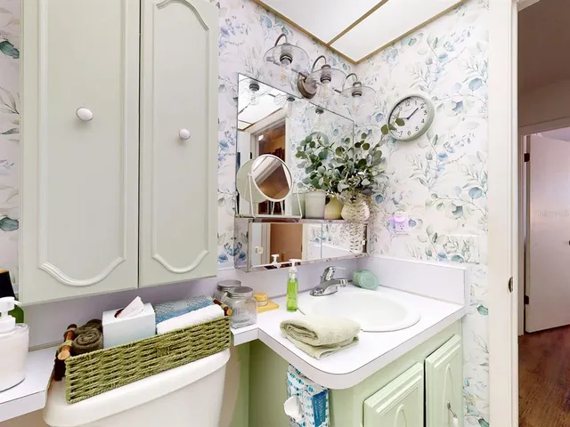view of a bathroom with a sink and mirror with bathtub
