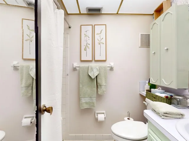a white toilet sitting next to a bathroom sink