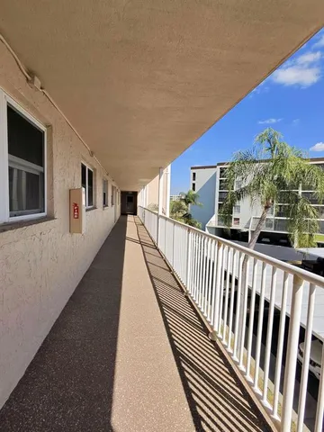 a view of a balcony with wooden floor and city view