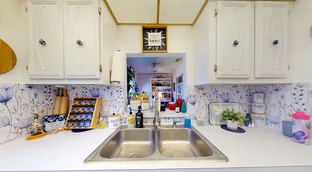 a view of kitchen with stainless steel appliances granite countertop a sink and dishwasher