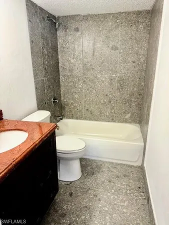 a living room with a couch and a potted plant