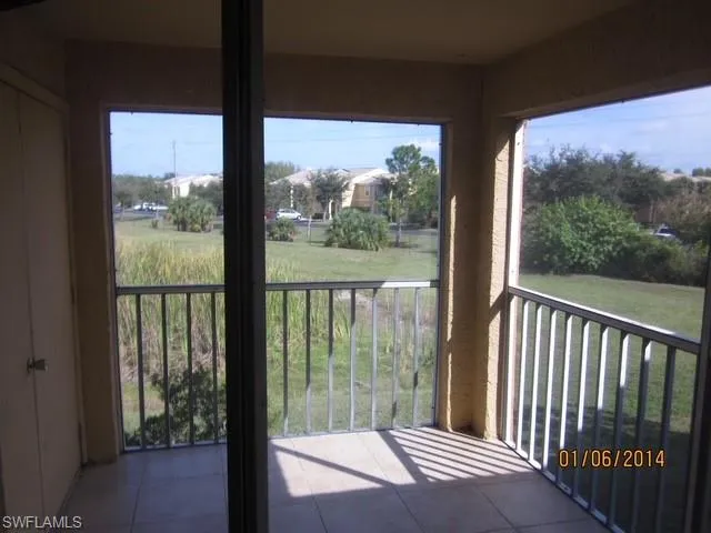 a view of a swimming pool with a yard and plants