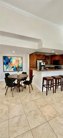 a kitchen with stainless steel appliances granite countertop a refrigerator a stove and a sink with wooden floors