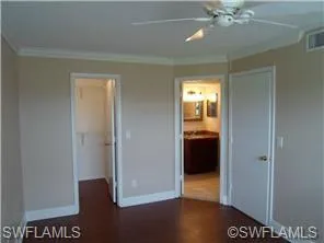 a view of a hallway with closet and a mirror