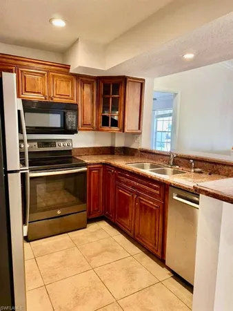 a kitchen with a refrigerator and a sink