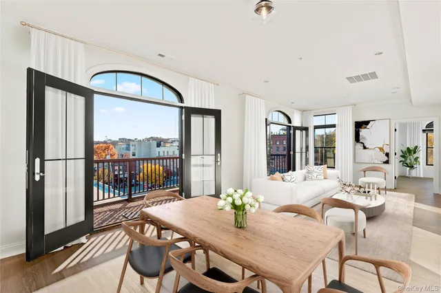 a view of a dining room with furniture window and wooden floor
