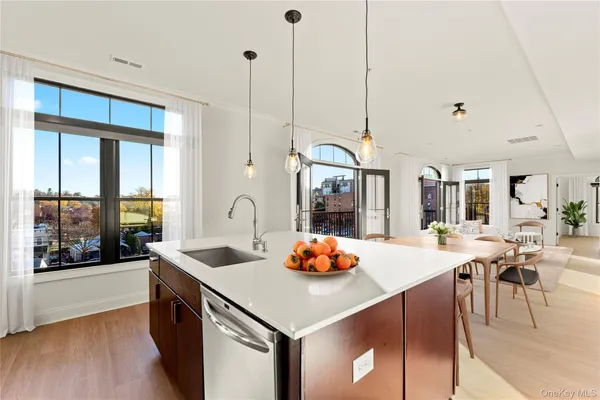 a kitchen with a sink a counter and chairs