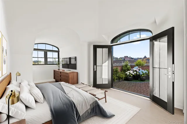 a bedroom with a bed and a large window
