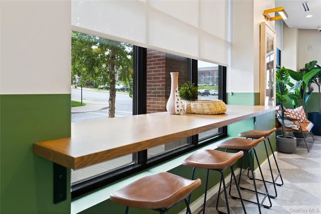 a room with pool table and a potted plant