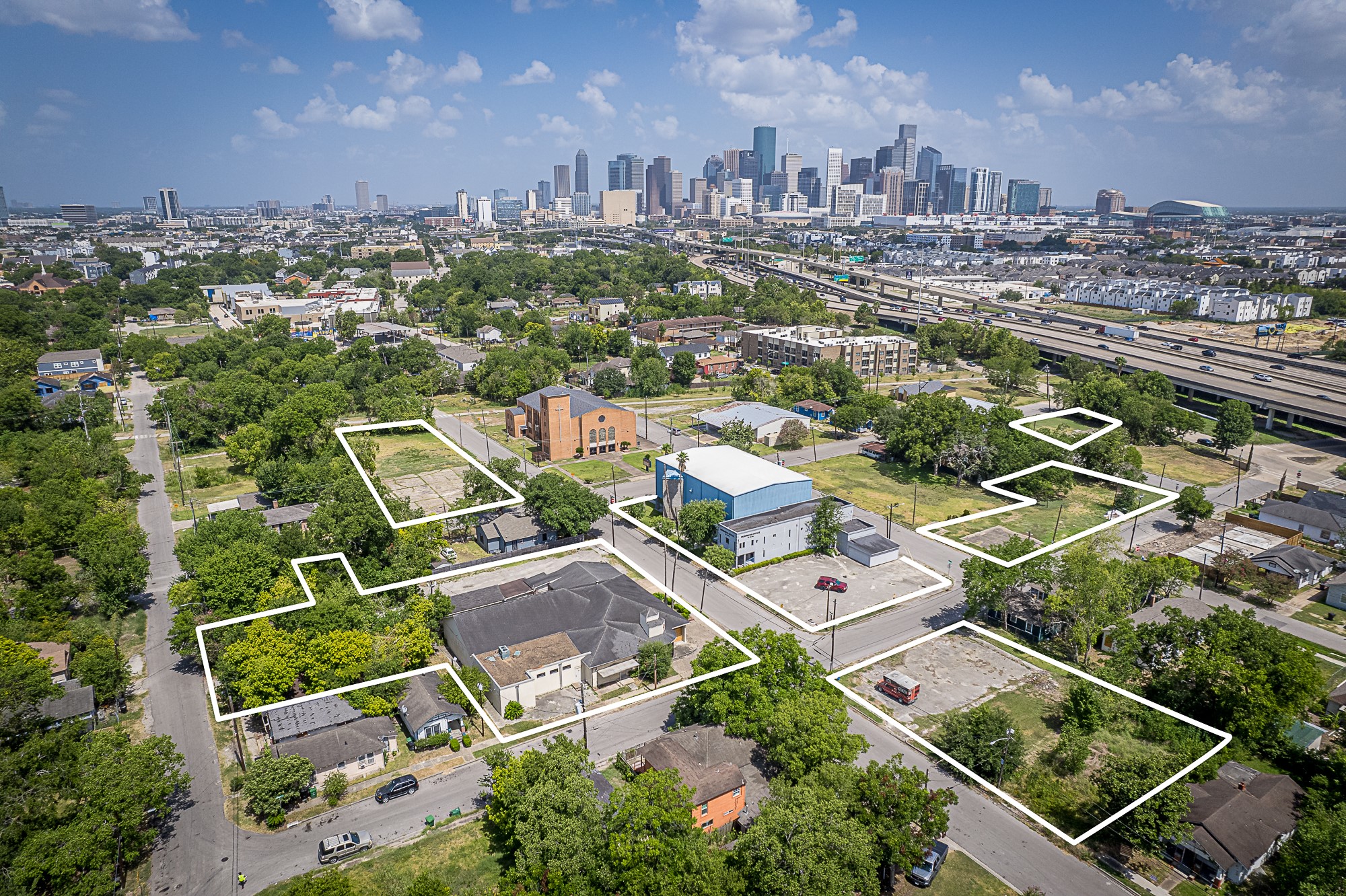 an aerial view of residential houses with city view