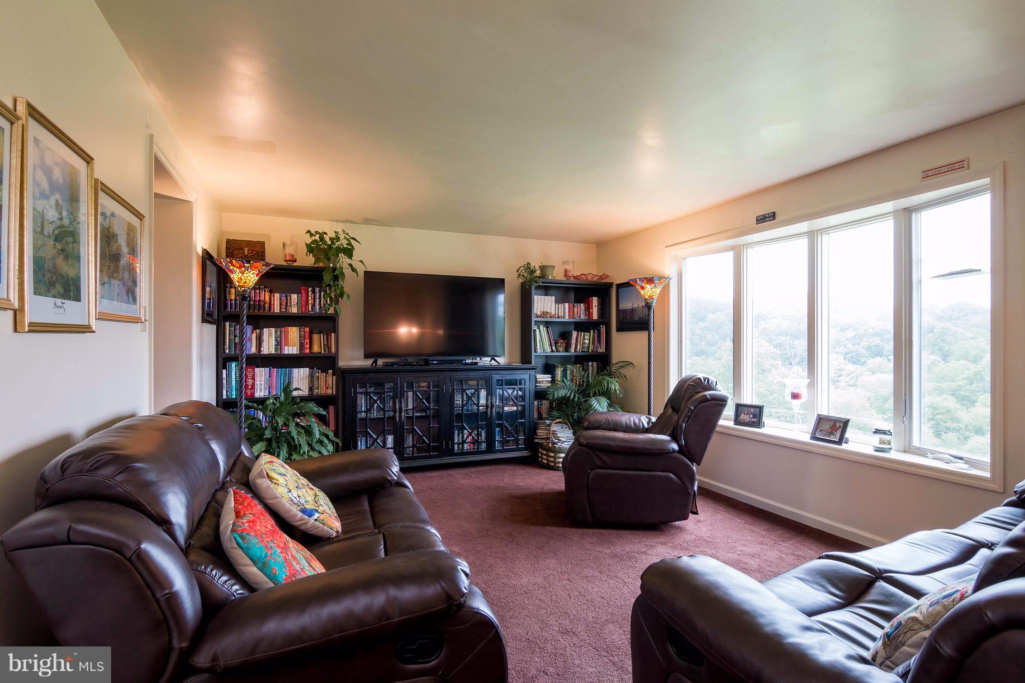 4009 Bill Moxley Road Mount Airy, MD 21771 - Photo 2 of 22 a living room with furniture and a flat screen tv