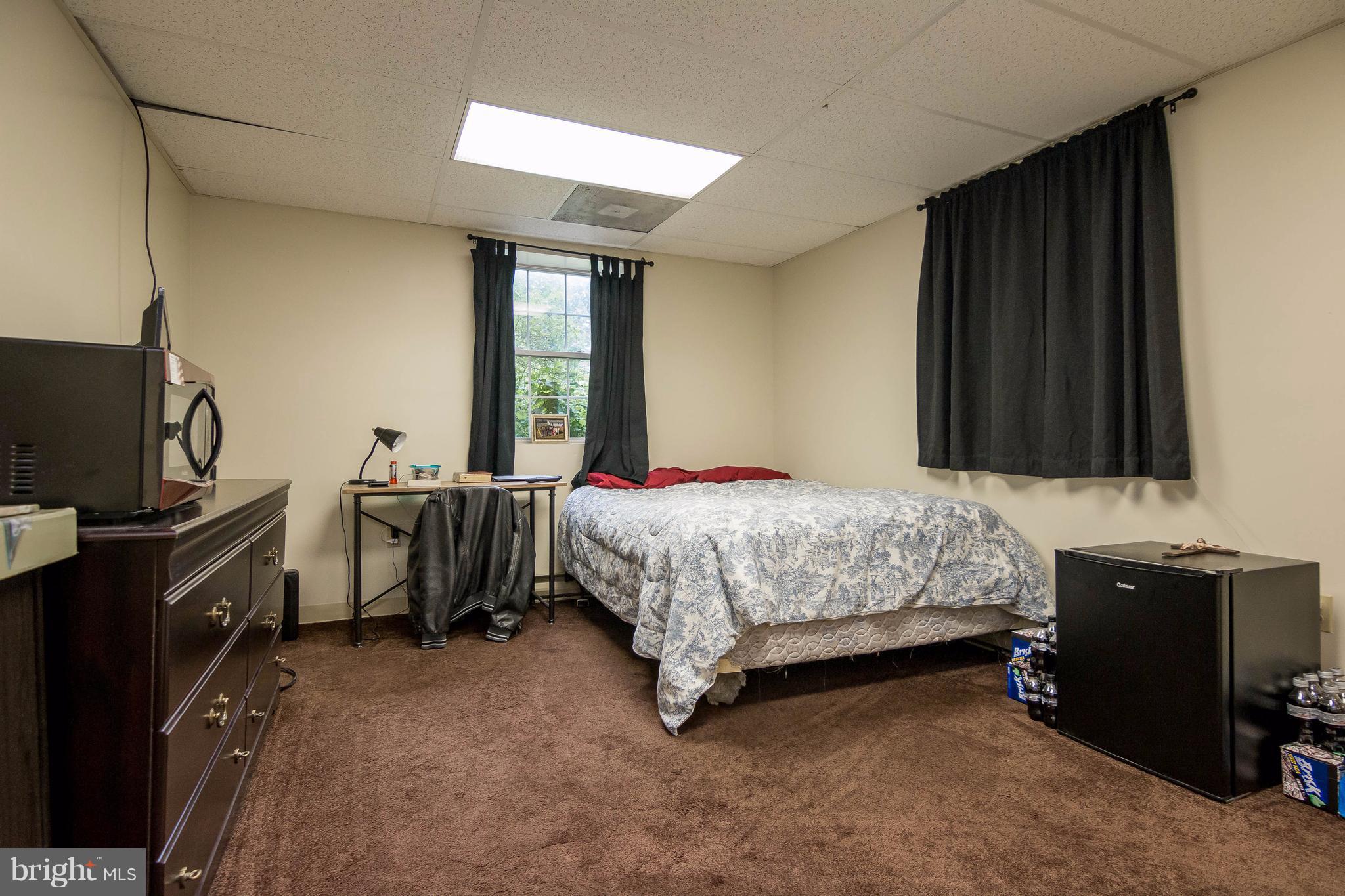 4009 Bill Moxley Road Mount Airy, MD 21771 - Photo 17 of 22 a bedroom with a bed and a flat tv screen on a dresser