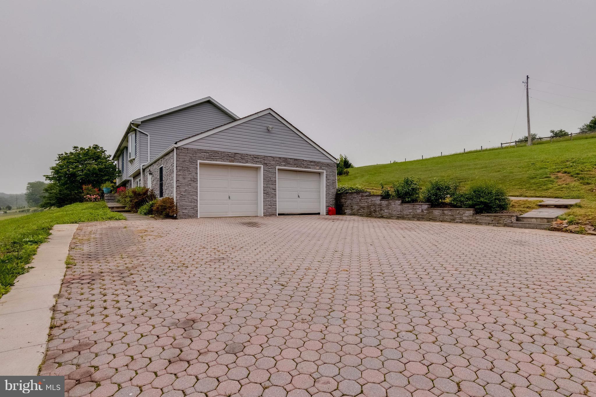4009 Bill Moxley Road Mount Airy, MD 21771 - Photo 20 of 22 a view of a house with a yard and potted plants