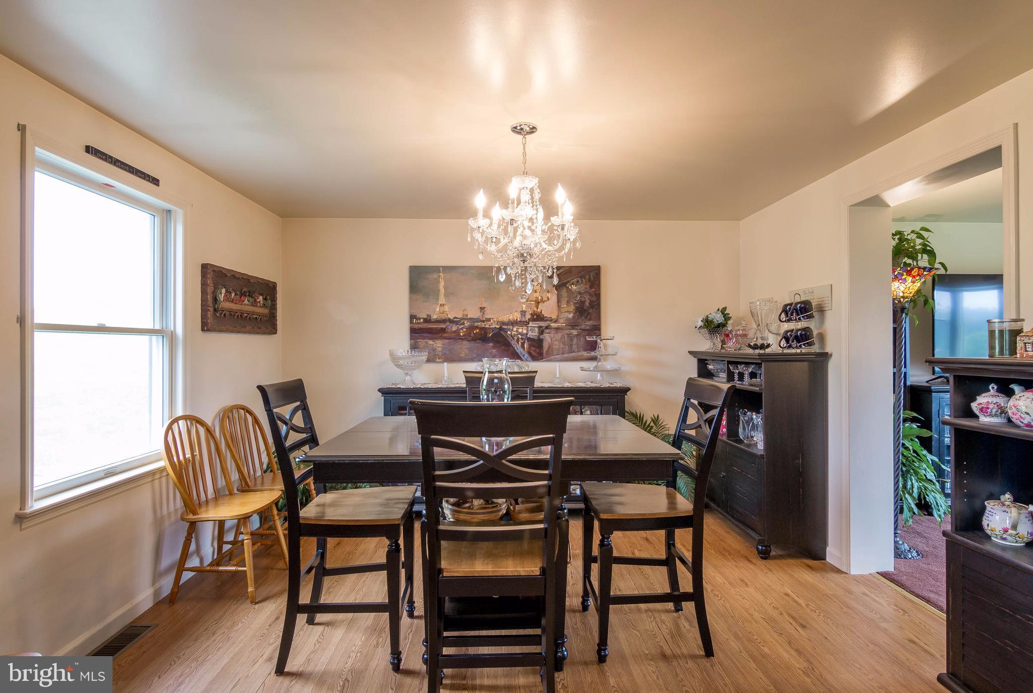 4009 Bill Moxley Road Mount Airy, MD 21771 - Photo 7 of 22 a view of a dining room with furniture and chandelier