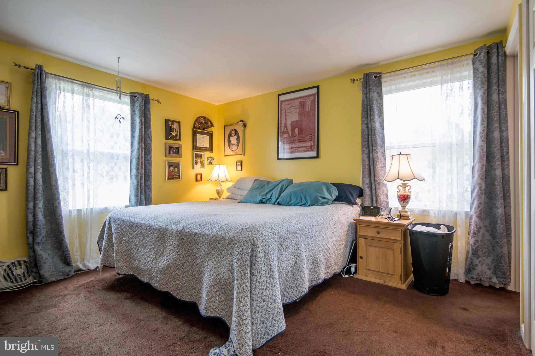 4009 Bill Moxley Road Mount Airy, MD 21771 - Photo 10 of 22 a bedroom with a bed and large windows