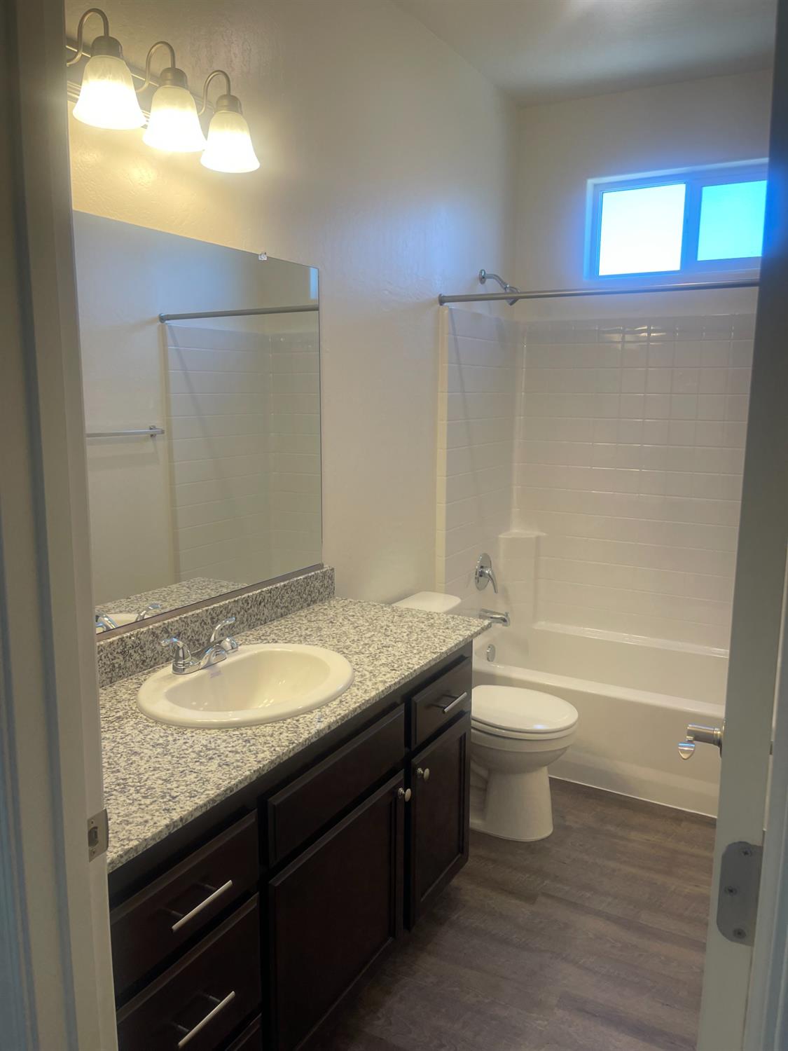 13320 4th Street, Unit LOT1 Parlier, CA 93648 - Photo 2 of 12 a bathroom with a granite countertop sink toilet and shower