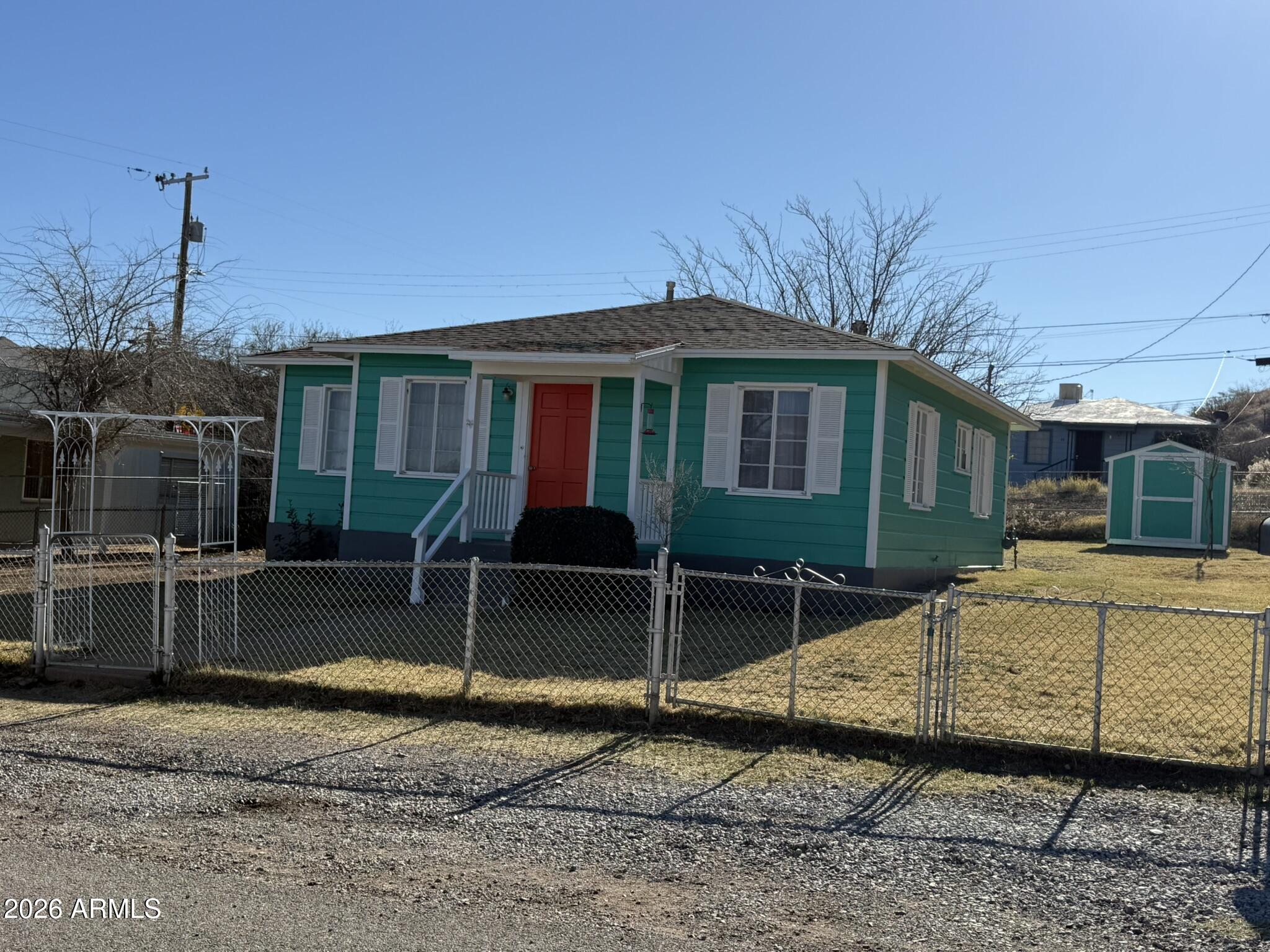 91 Neptune Avenue Bisbee, AZ 85603 - Photo 1 of 12 a view of a house with a backyard