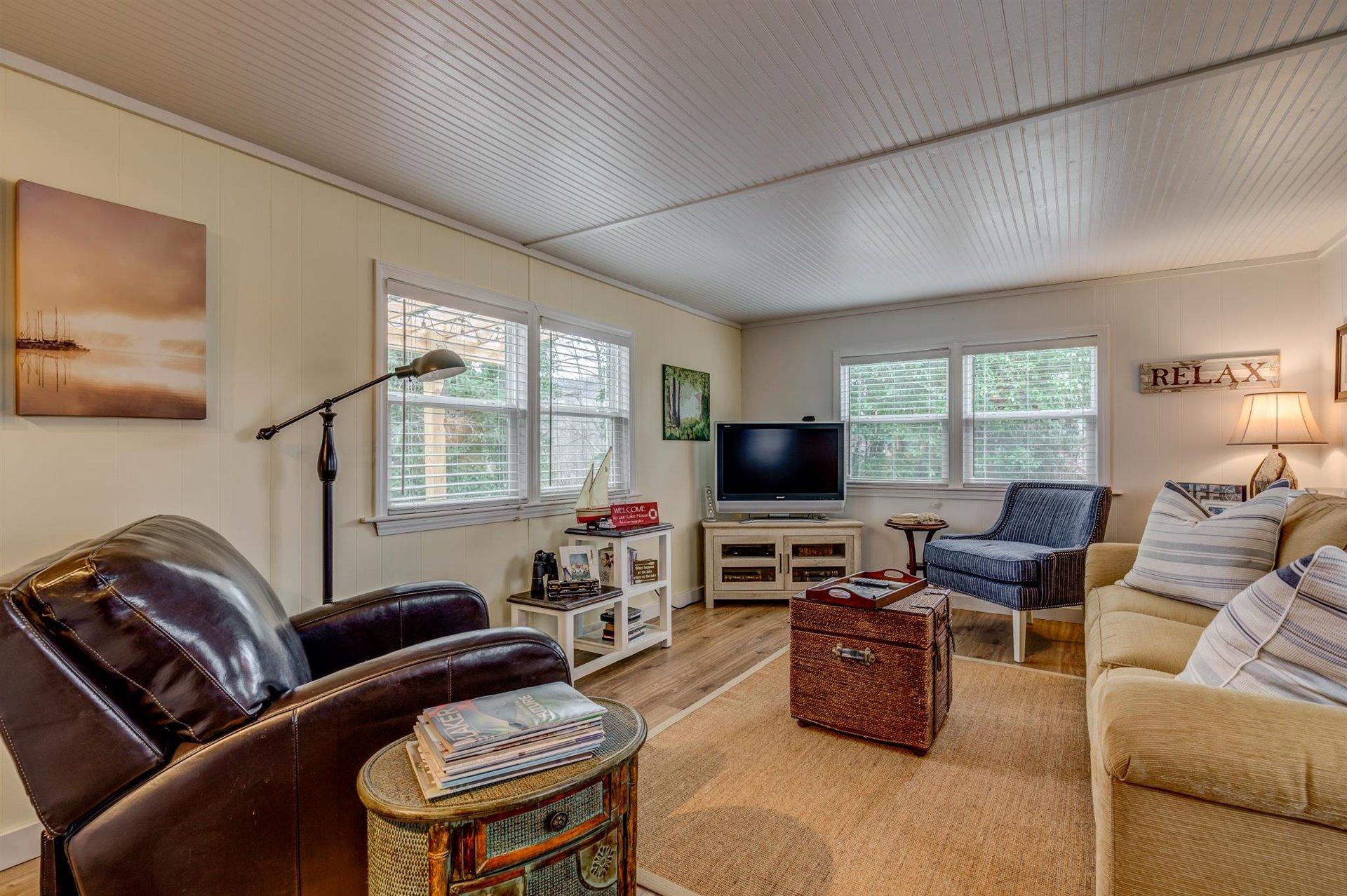 232 Munsons Road Penhook, VA 24137 - Photo 12 of 50 a living room with furniture and a flat screen tv