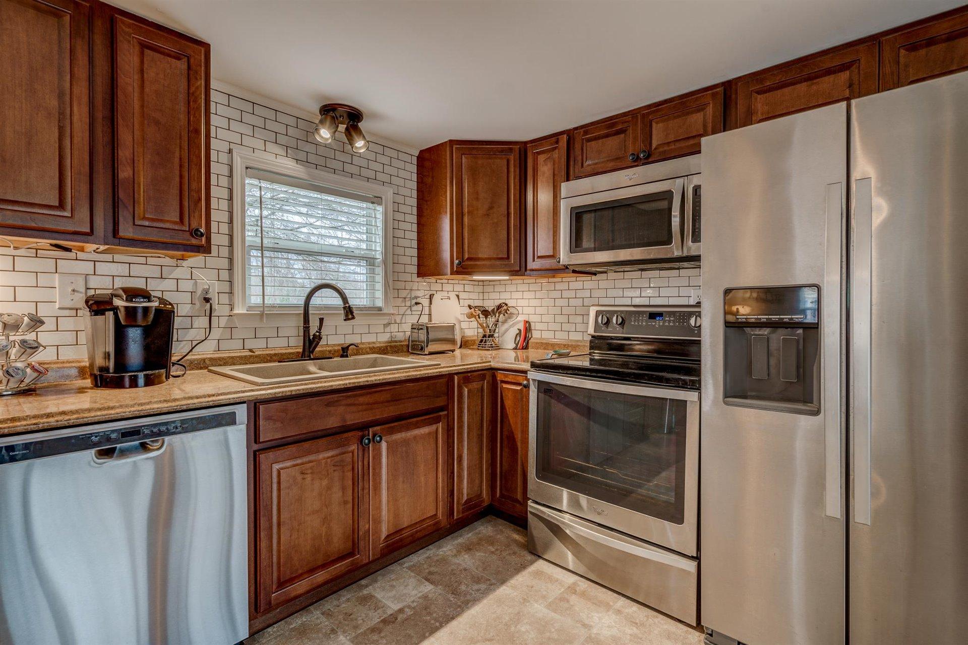 232 Munsons Road Penhook, VA 24137 - Photo 18 of 50 a kitchen with a sink stove and microwave