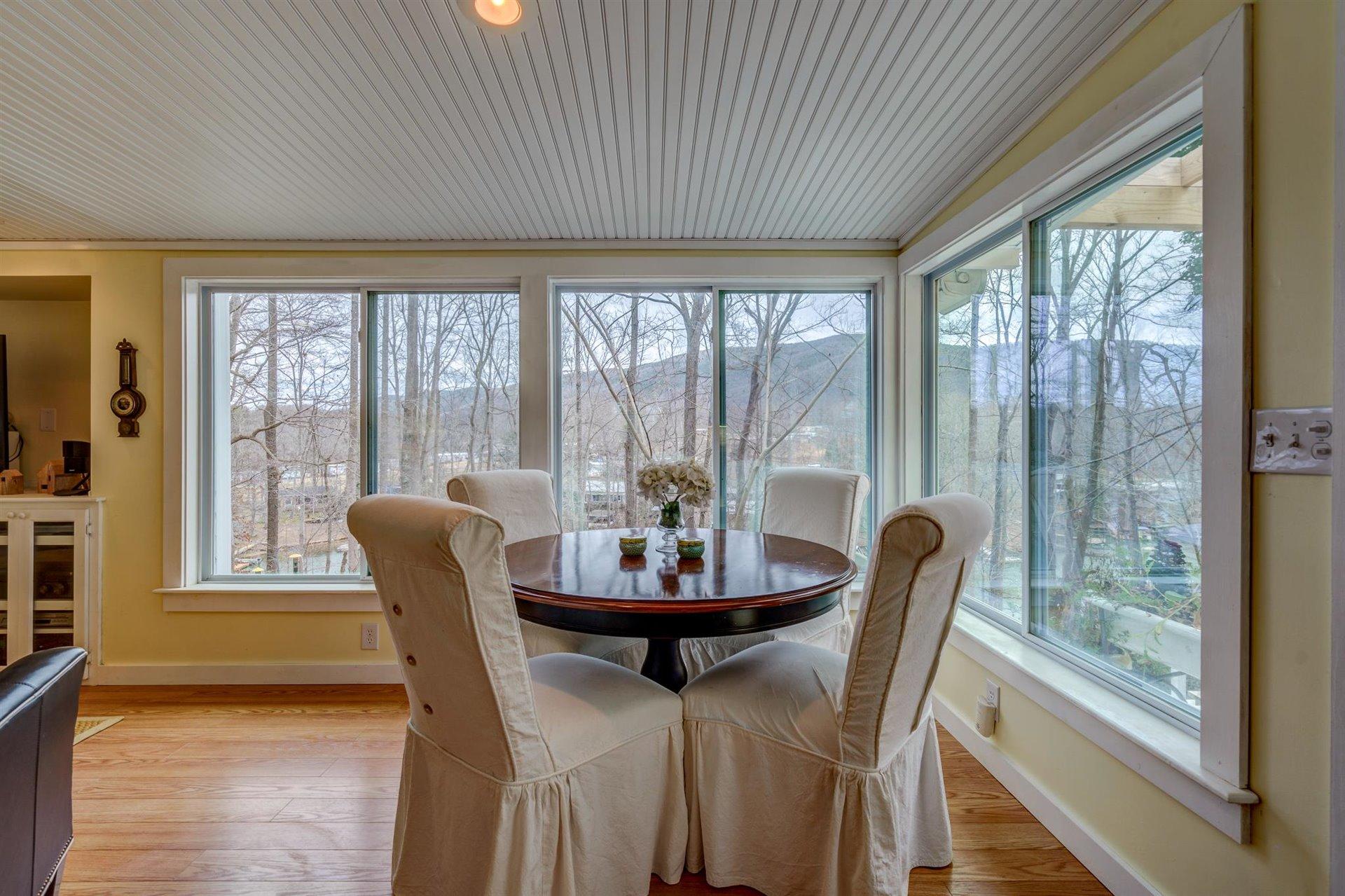 232 Munsons Road Penhook, VA 24137 - Photo 19 of 50 a view of a dining room with furniture large windows and wooden floor