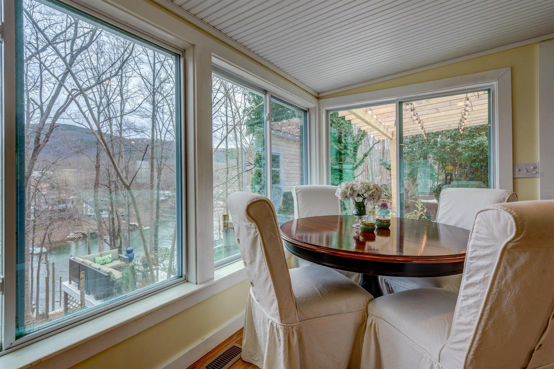 232 Munsons Road Penhook, VA 24137 - Photo 20 of 50 a dining room with furniture wooden floor and a potted plant