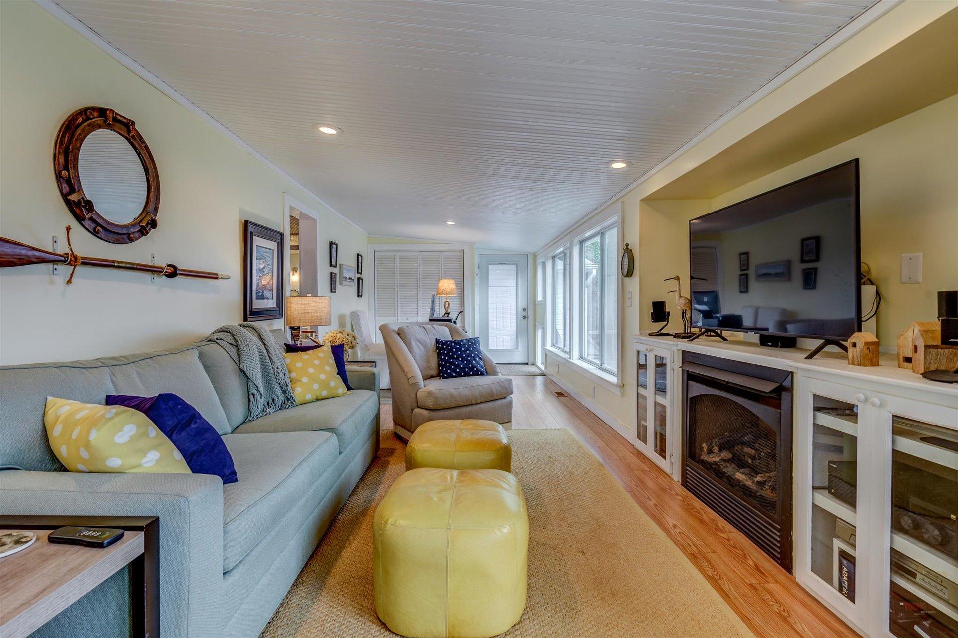 232 Munsons Road Penhook, VA 24137 - Photo 21 of 50 a living room with furniture a fireplace and a flat screen tv