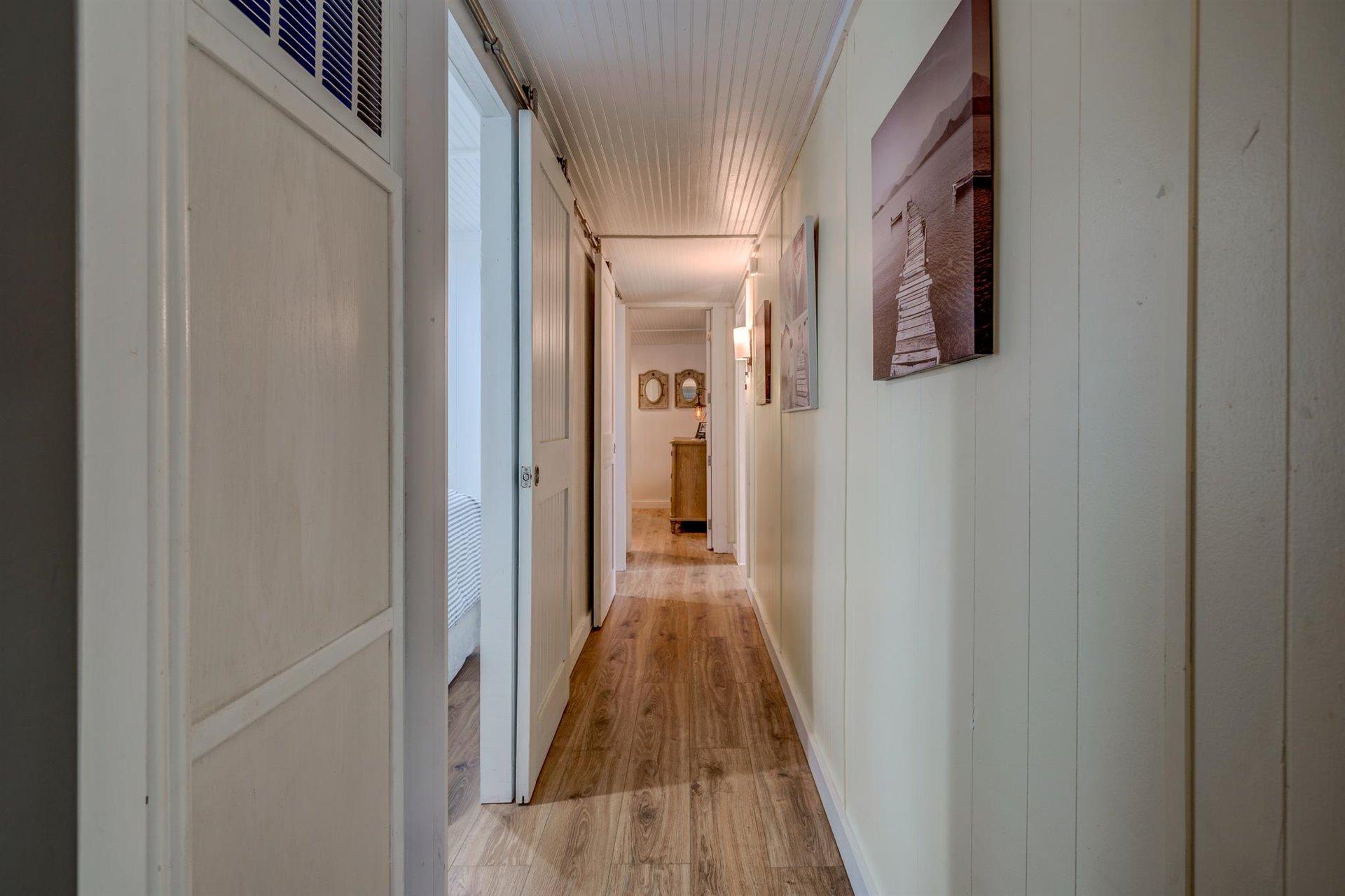 232 Munsons Road Penhook, VA 24137 - Photo 25 of 50 a view of a hallway with wooden floor and a bathroom