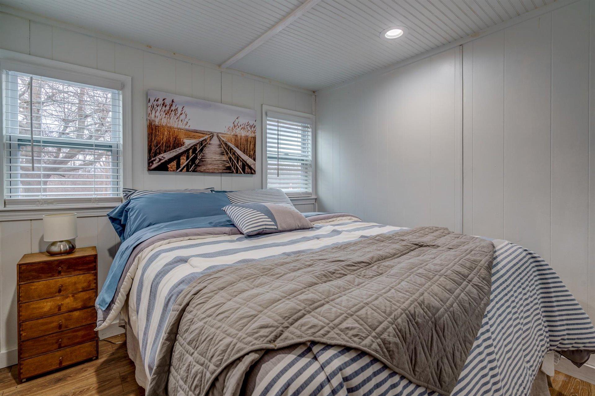 232 Munsons Road Penhook, VA 24137 - Photo 26 of 50 a bedroom with a bed and a painting on the wall