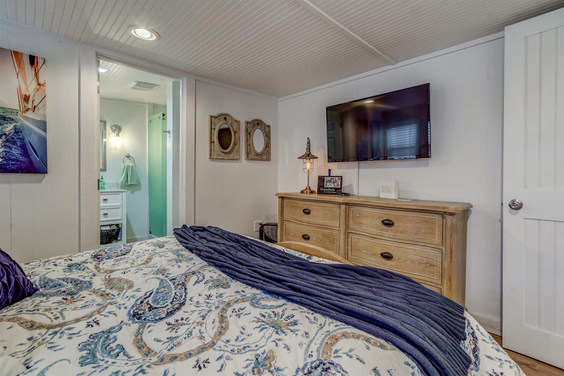 232 Munsons Road Penhook, VA 24137 - Photo 29 of 50 a bedroom with a bed and a flat screen tv