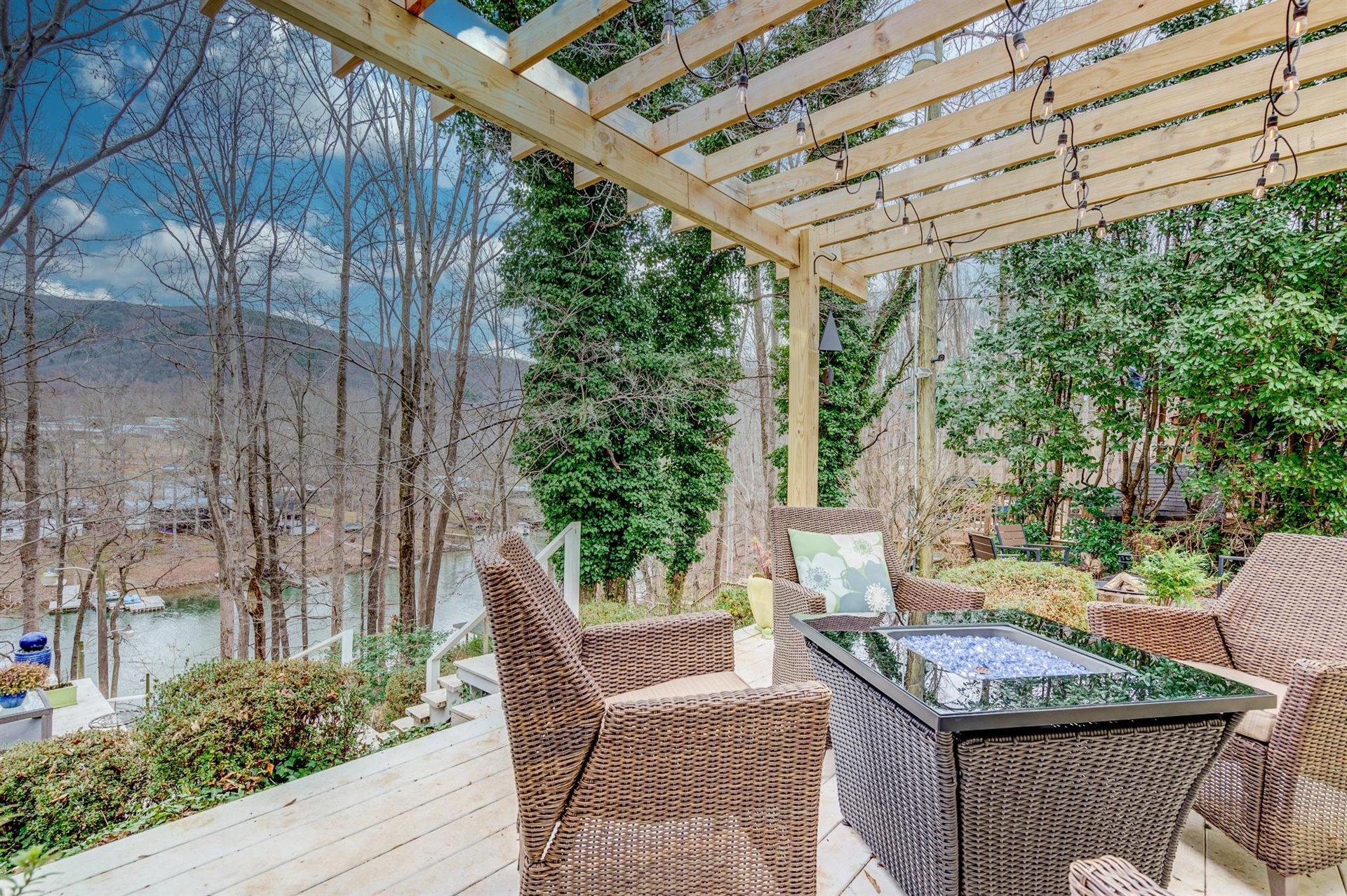 232 Munsons Road Penhook, VA 24137 - Photo 32 of 50 a view of a patio with table and chairs and potted plants