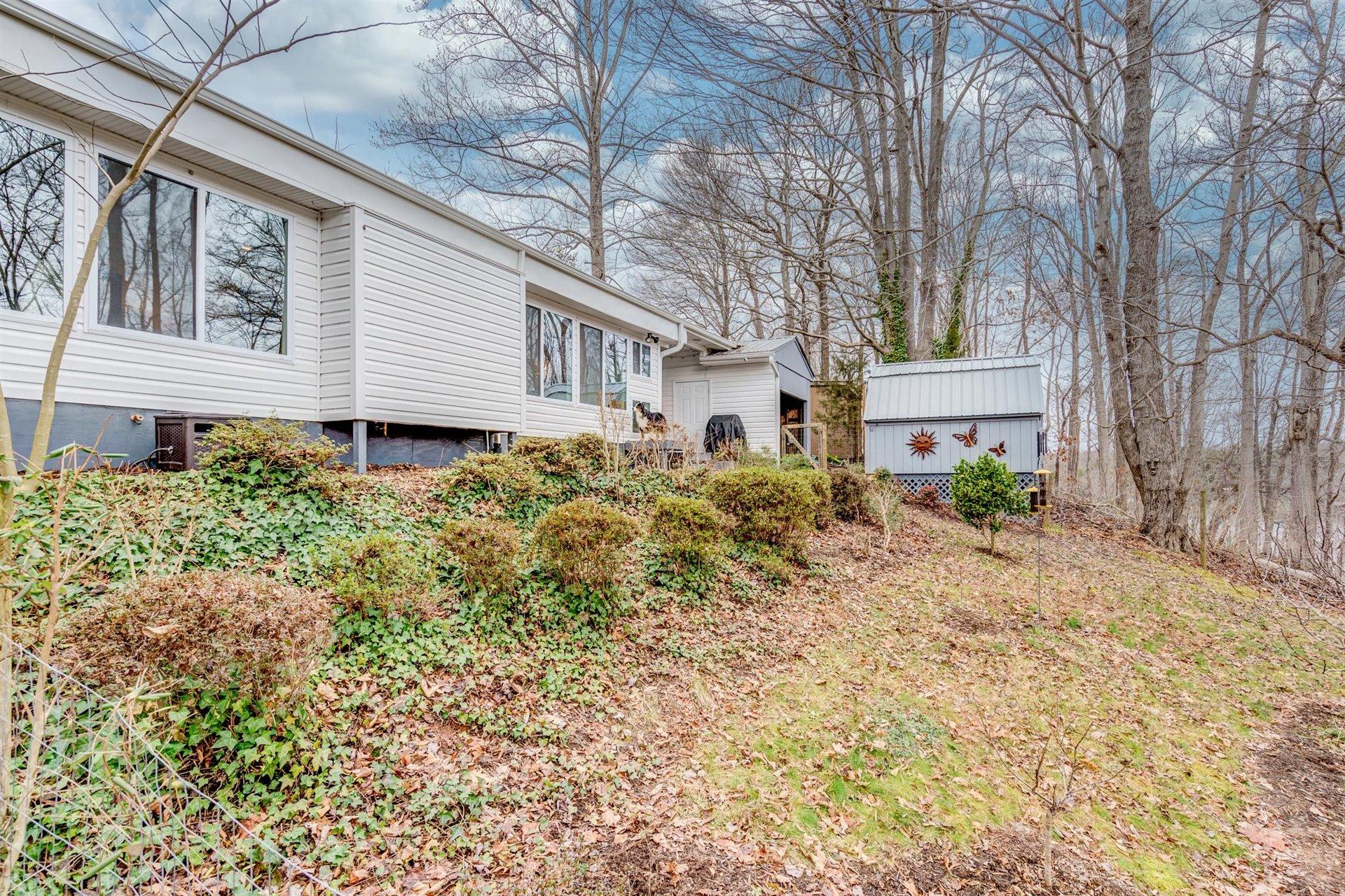 232 Munsons Road Penhook, VA 24137 - Photo 34 of 50 a front view of a house with garden