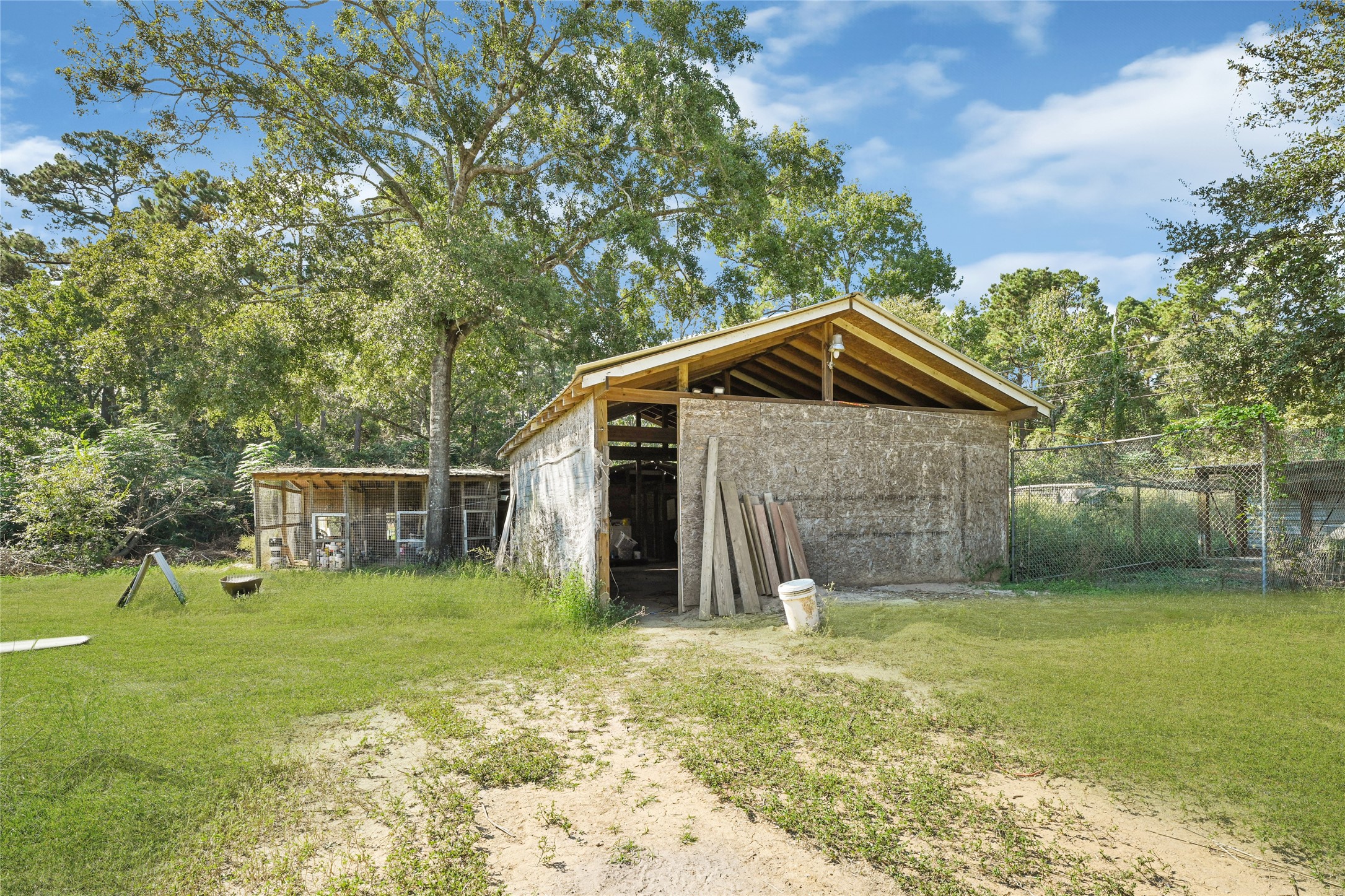 157 Jim Browder Road Willis, TX 77378 - Photo 3 of 17 a view of a backyard with a small cabin
