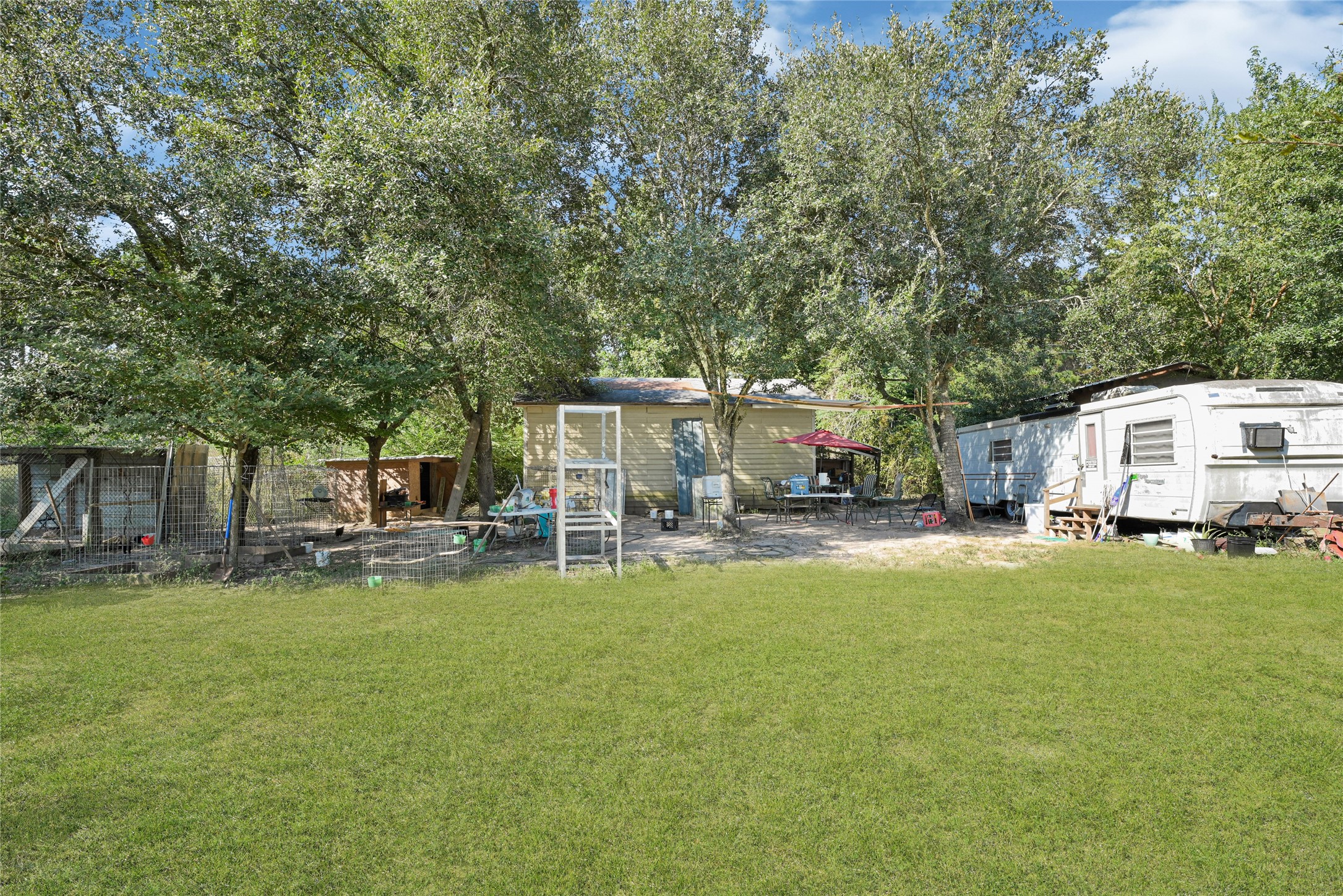 157 Jim Browder Road Willis, TX 77378 - Photo 4 of 17 a view of a house with backyard and sitting area