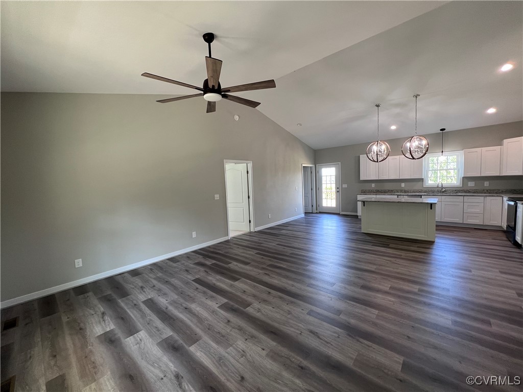 954 Monroe Church Road Rice, VA 23966 - Photo 4 of 12 an empty room with wooden floor a ceiling fan and kitchen view