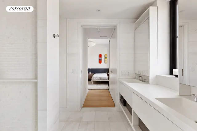 a bathroom with a tub a sink and mirror