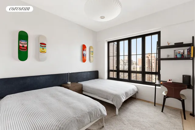 a bedroom with a bed and a large window