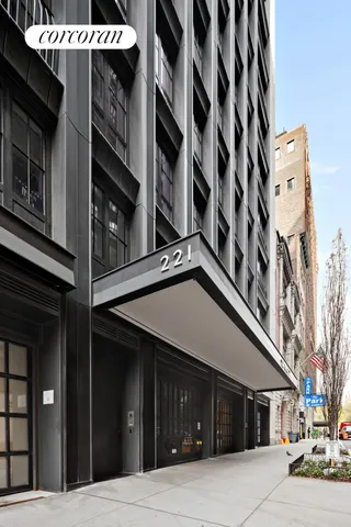 a spacious bedroom with a bed and a chandelier