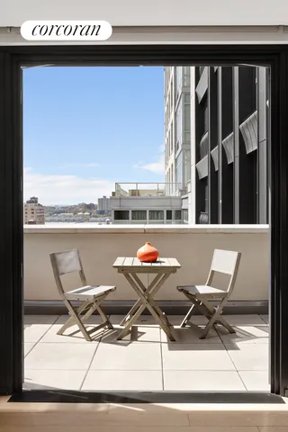 a living room with furniture and a floor to ceiling window
