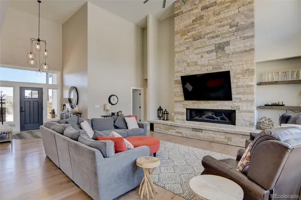 a living room with fireplace furniture and a flat screen tv