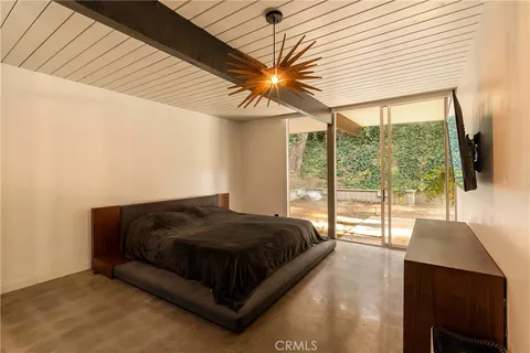 a spacious bedroom with a bed and a large window