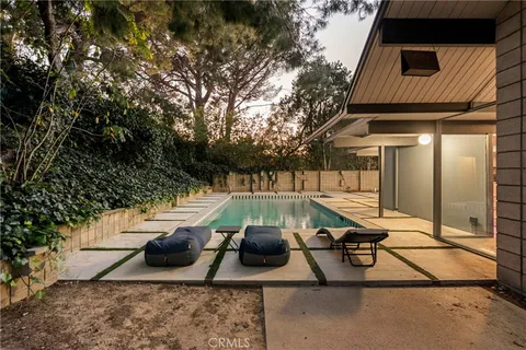 a view of a swimming pool with chair and table