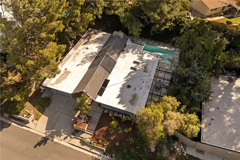 an aerial view of a house with a yard and lake view