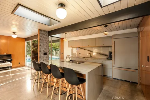 a kitchen with a sink appliances and cabinets